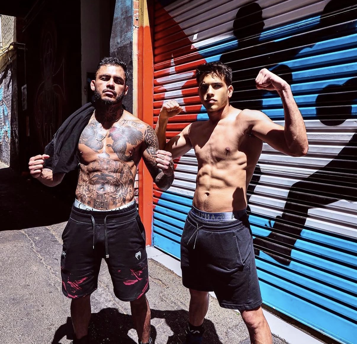 Marco Beltrán and Ruben flexing in a laneway