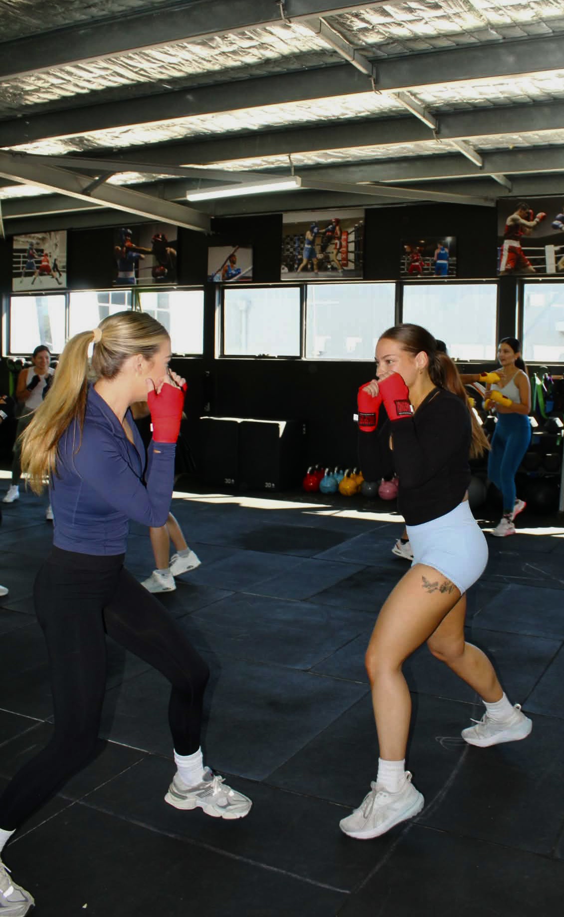 Members sparring with red wraps