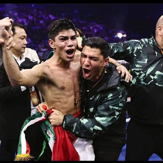 Ruben celebrating victory with Pedro Guevara and the Mexican flag